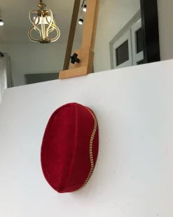 A Red and gold lines ceremonial African Traditional hat