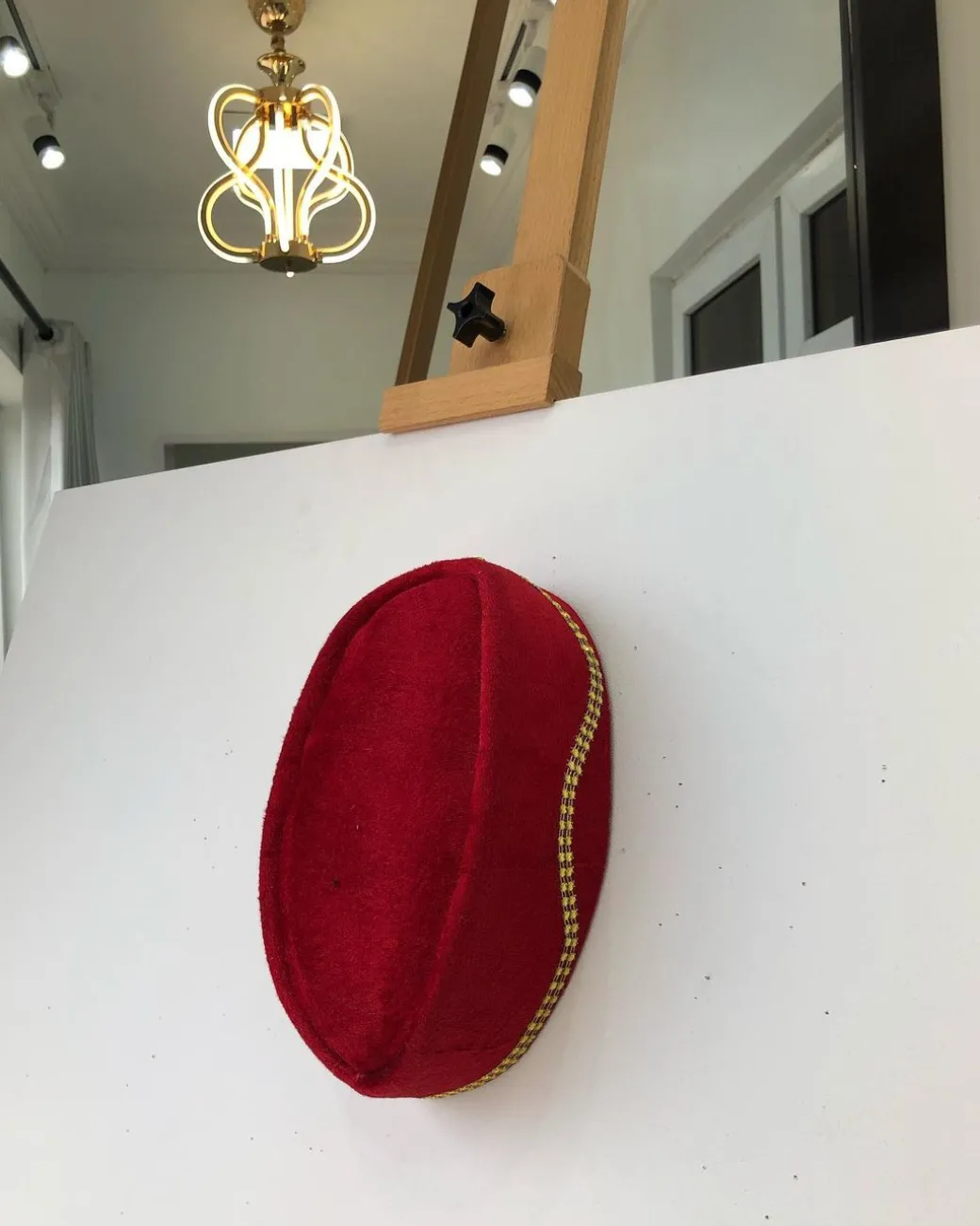 A Red and gold lines ceremonial African Traditional hat