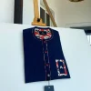 A red and midnight blue pin stripe senators kaftan with mixed red paisley pocket and neck detailing.