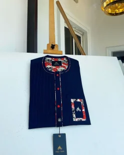 A red and midnight blue pin stripe senators kaftan with mixed red paisley pocket and neck detailing.
