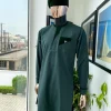 A reloaded British racing green, Monochrome embroidery with soaked Italian velvet detailing long sleeve Kaftan and sokoto
