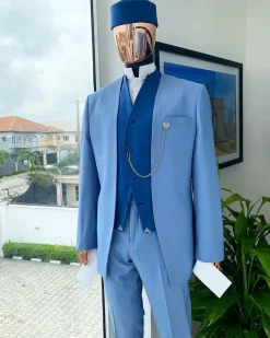 A reloaded ceremonial “Ayeye” Ijade 20/21 – Look 5- “Tokunbo” look. Powder blue half section back slant cut jacket
