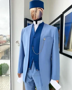 A reloaded ceremonial “Ayeye” Ijade 20/21 – Look 5- “Tokunbo” look. Powder blue half section back slant cut jacket