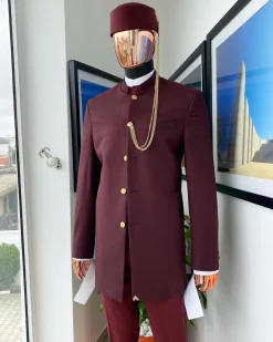 A Reloaded Ceremonial “Ayeye” Ijade 20/21 – Look 10- “Ajala”. A burgundy safari jacket with gold buttons, inner waist coat, turtle neck shirt, hat and pant trousers.
