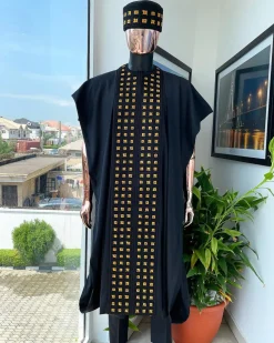 A Reloaded charcoal black, connected square embroidery design with matching gold and red Swarovski stone details agbada