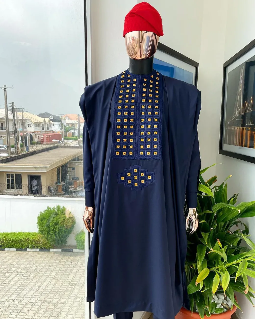 A reloaded midnight blue, connected square embroidery design with matching gold and red Swarovski stone details agbada
