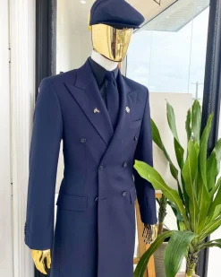 A reloaded monochrome “peaky Blinder” midnight blue peak lapel trench suit