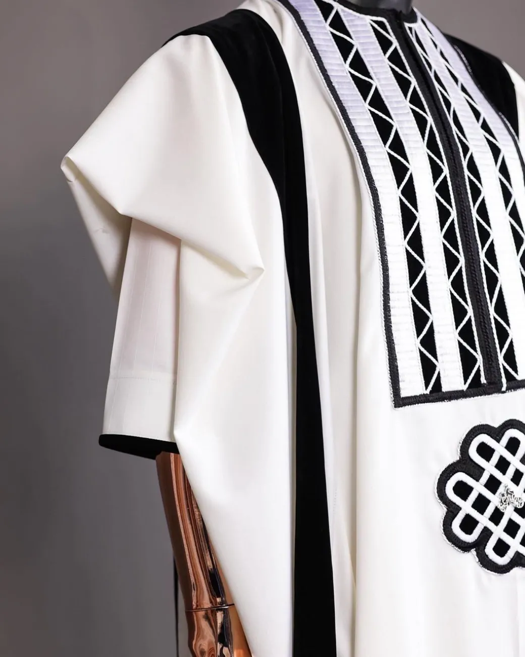 A Reloaded white Monochrome embroidery with charcoal black soaked Italian velvet detailing agbada