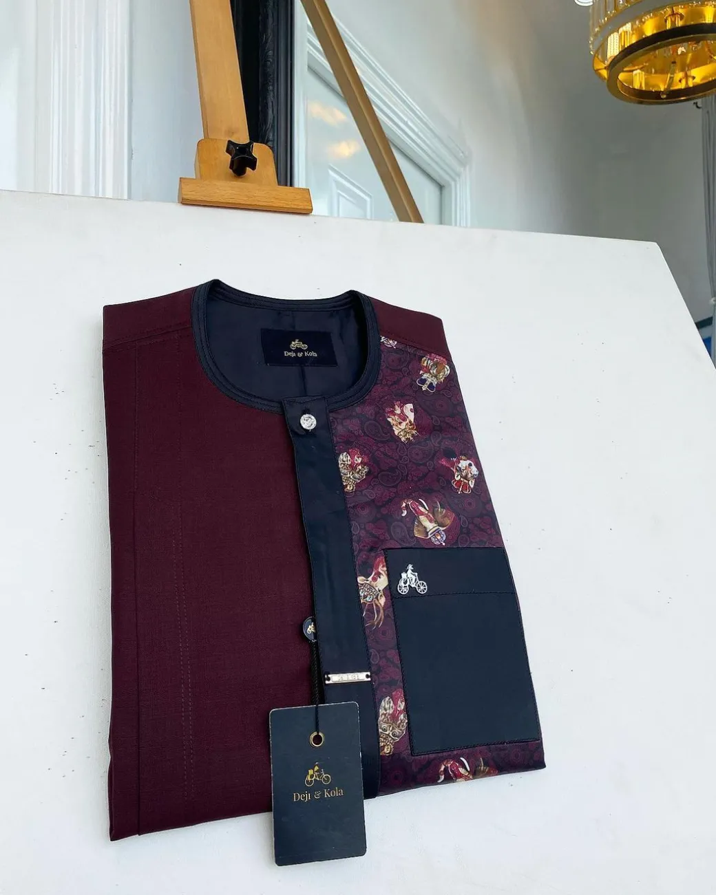 A sangria purple, front flap with silver clear view Swarovski button, half left section matching paisley senator kaftan native.