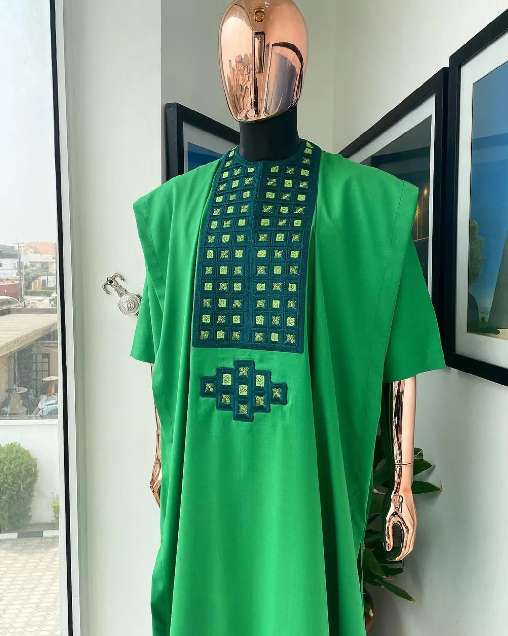 A Shamrock green, connected square embroidery design with matching silver and parakeet green Swarovski stone details agbada