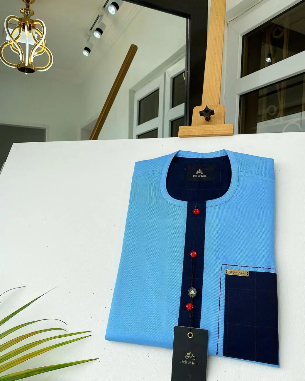 A Skye blue Herringbone fabric kaftan, midnight blue check stripe mix, and matching Swarovski button