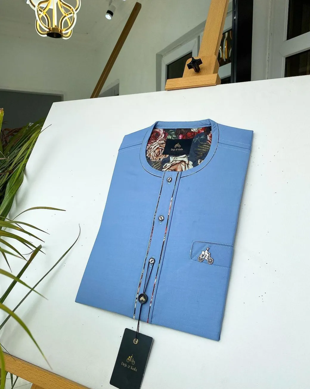 A Skye blue with paisley detailing, front flap with a matching Swarovski button detailing African kaftan and sokoto
