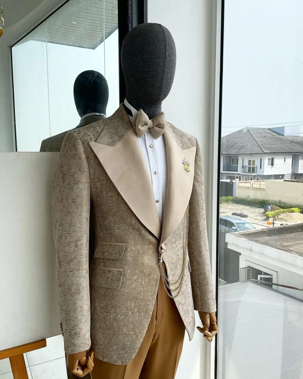 A splash of tortilla and wheat brown peak lapel metallic jacquard tuxedo suit