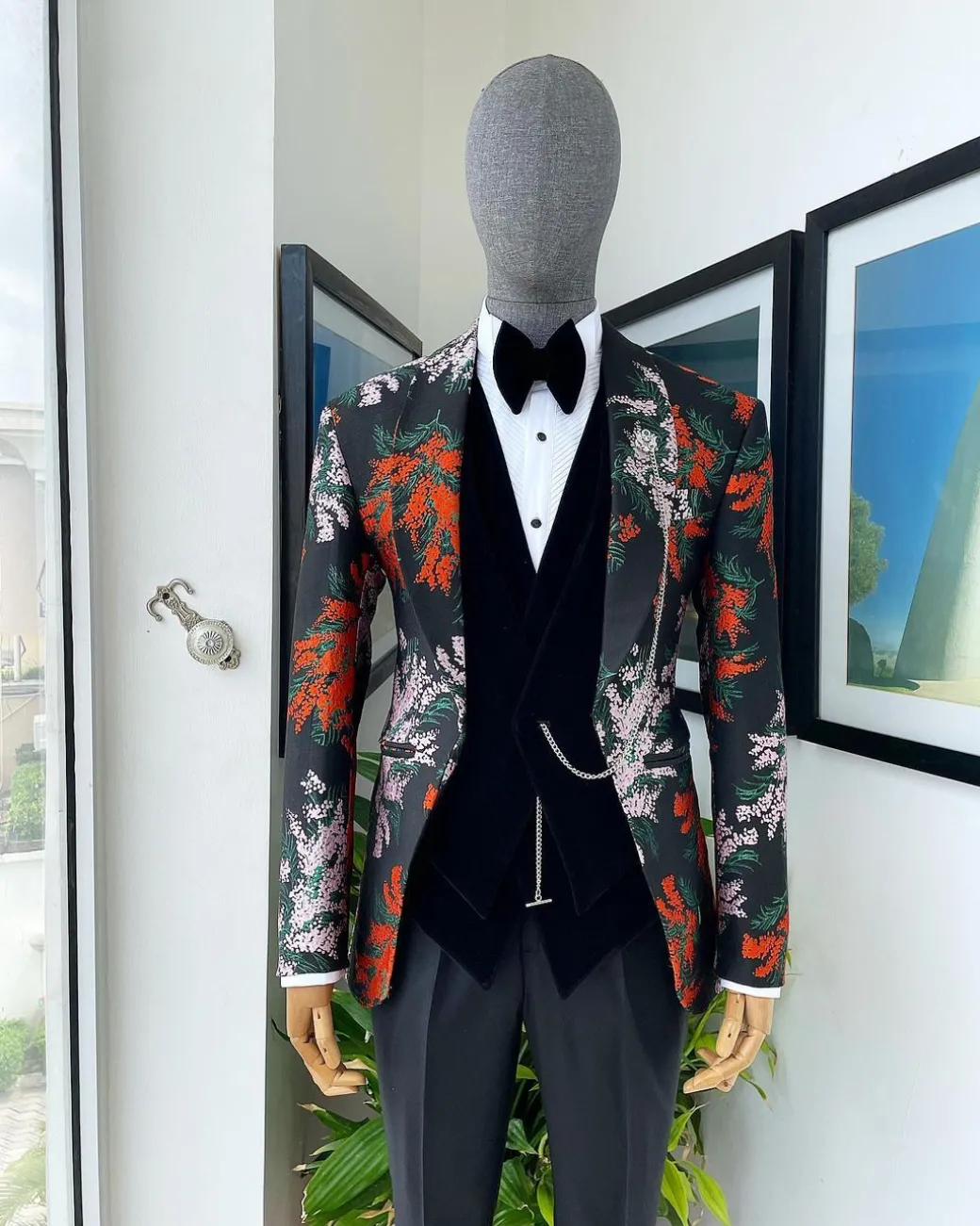 A “spring” orange, pink and green splashed floral layered front cut, shawl lapel tuxedo suit