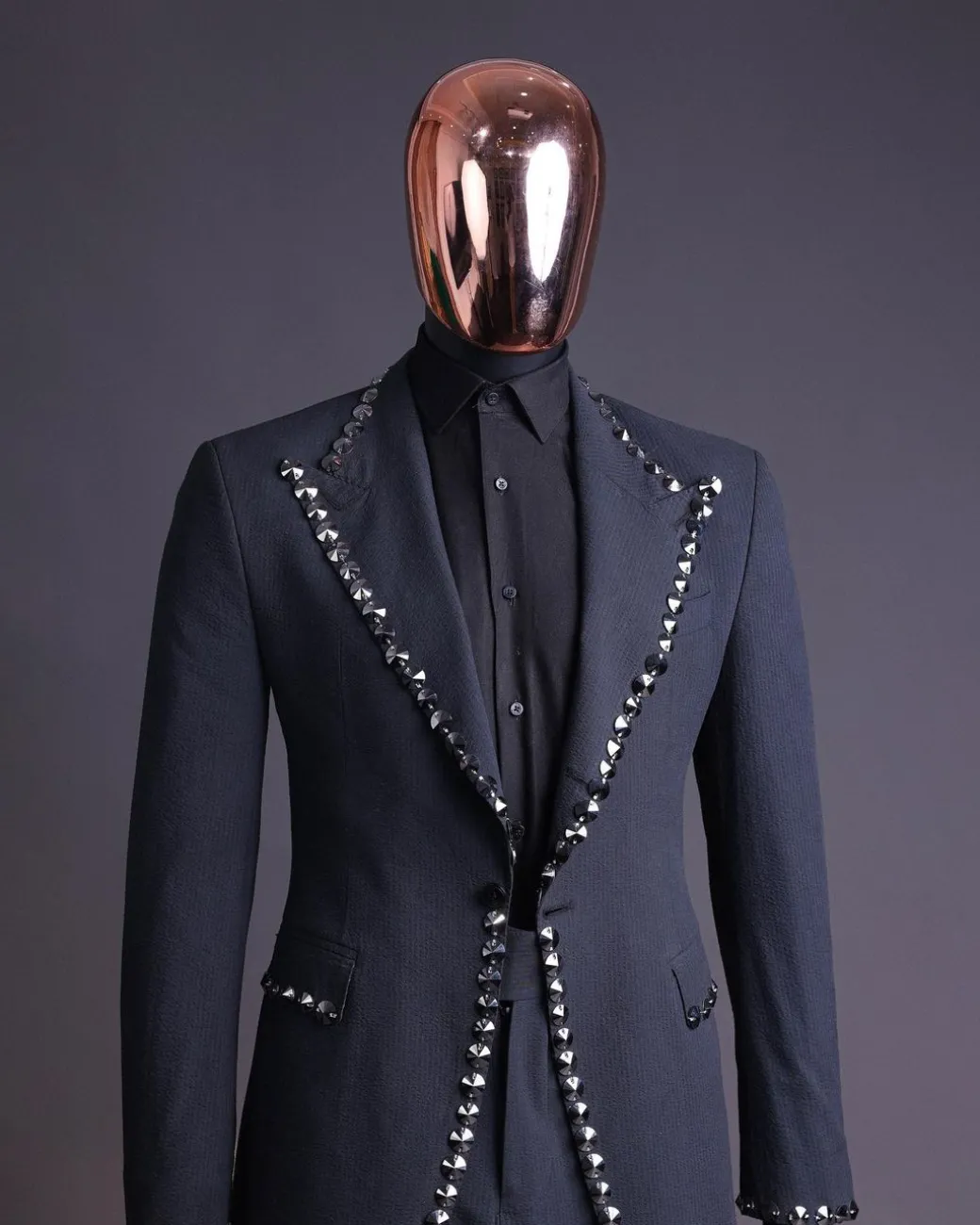 A steel black, seer sucker fabric, knitted, peak lapel suit