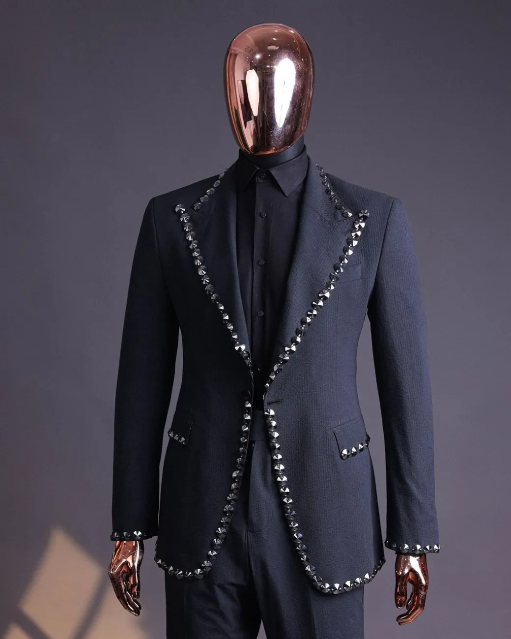 A steel black, seer sucker fabric, knitted, peak lapel suit