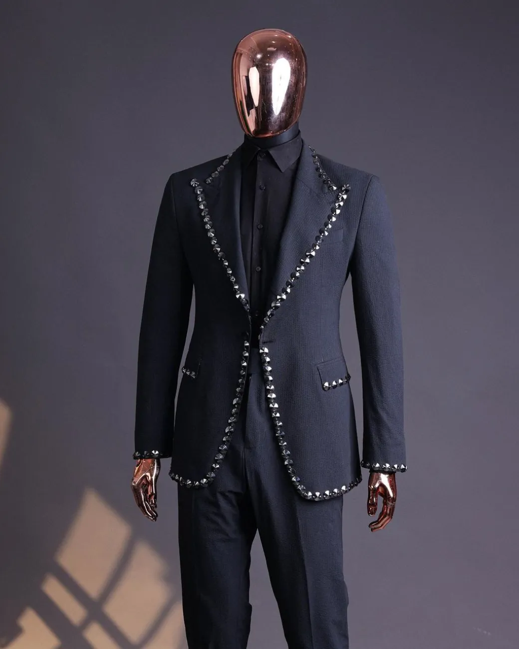 A steel black, seer sucker fabric, knitted, peak lapel suit