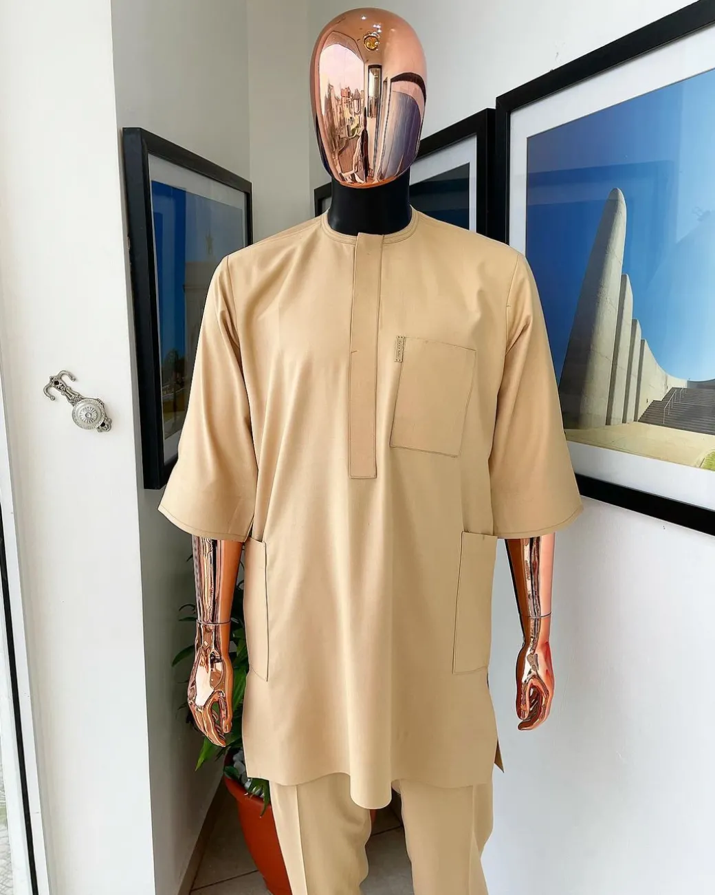 A Tan Brown, connected iron drop embroidery design with matching Agbada