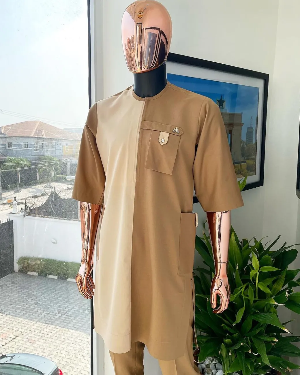A Tortilla and peanut brown combat front and side pocket with a clear view of Swarovski stone detailing African traditional senator Kaftan native.