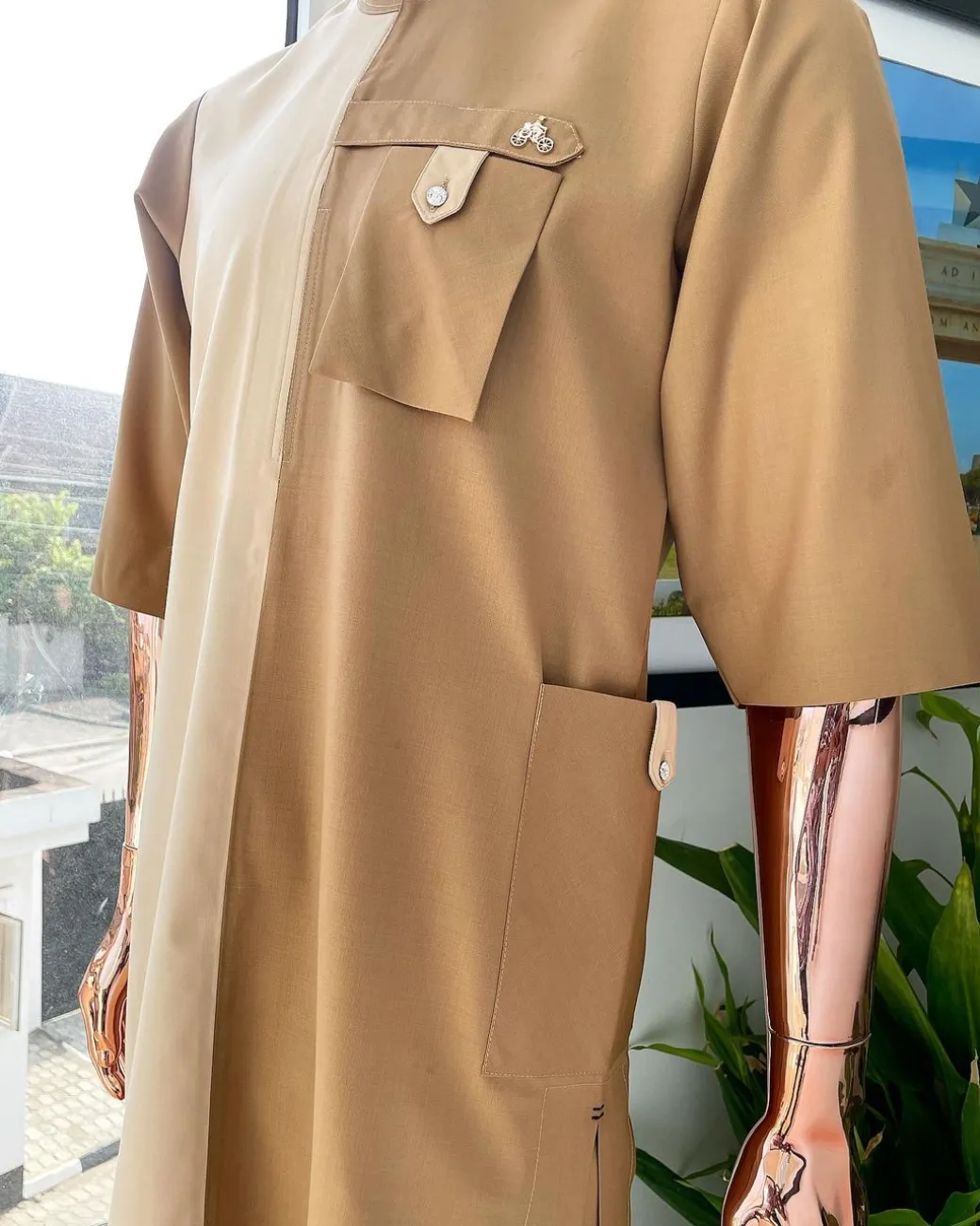 A Tortilla and peanut brown combat front and side pocket with a clear view of Swarovski stone detailing African traditional senator Kaftan native.