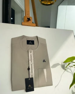 A tortilla brown, connected triangle front flap, and pocket embroidery detailing African traditional senator Kaftan native