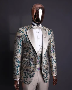 A Tortilla brown, emerald green, gold and splash of burgundy metallic floral jacquard peak lapel tuxedo suit