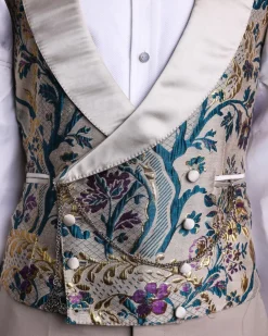 A Tortilla brown, emerald green, gold and splash of burgundy metallic floral jacquard peak lapel tuxedo suit