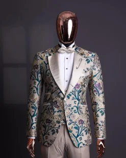A Tortilla brown, emerald green, gold and splash of burgundy metallic floral jacquard peak lapel tuxedo suit