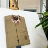 A tortilla brown, lipstick red clear view Swarovski buttons detailing African traditional senator kaftan native.