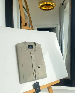 A warm grey, patch pocket, front flap with clear view jet black Swarovski button details African traditional senator kaftan native.