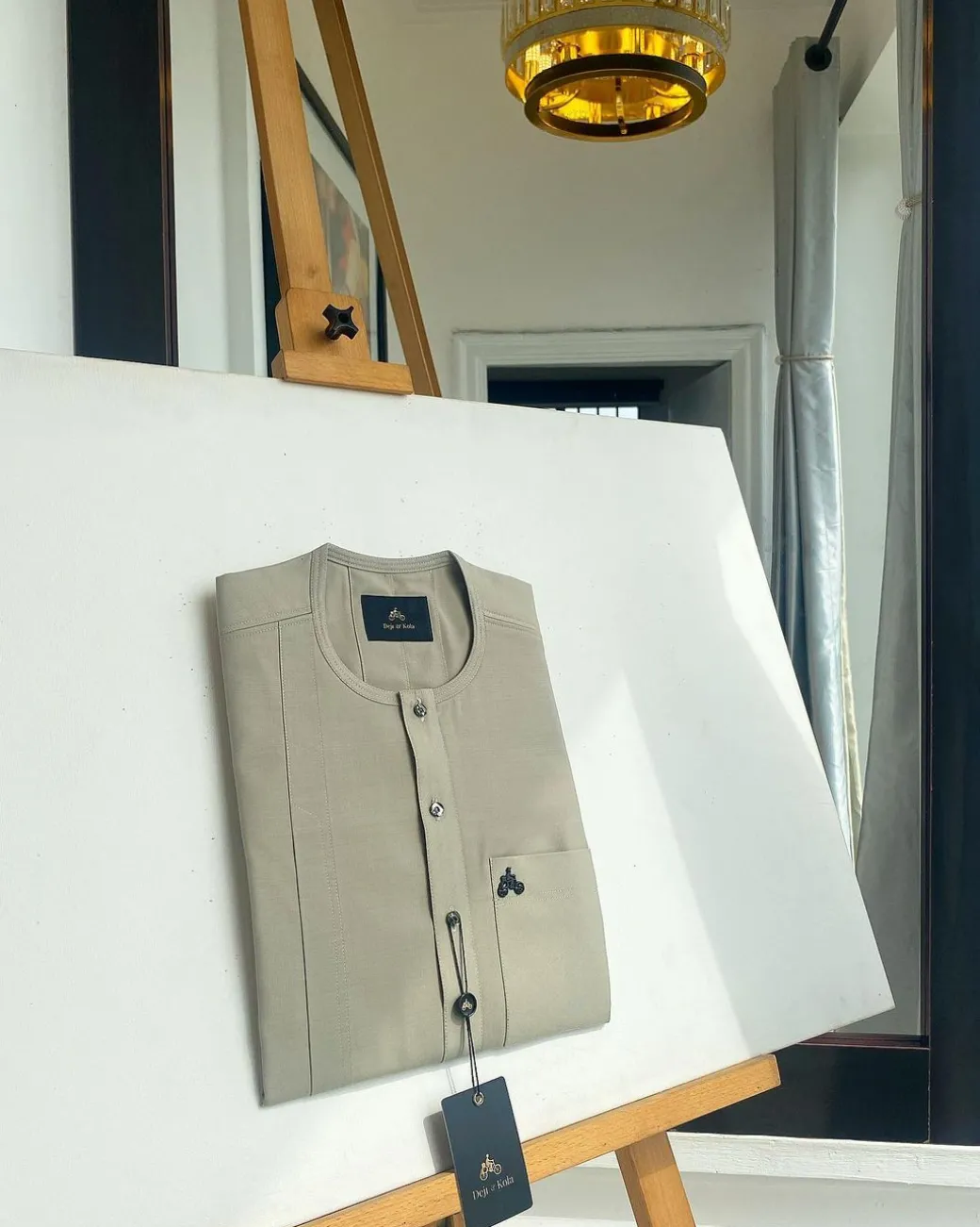 A warm grey, patch pocket, front flap with clear view jet black Swarovski button details African traditional senator kaftan native.