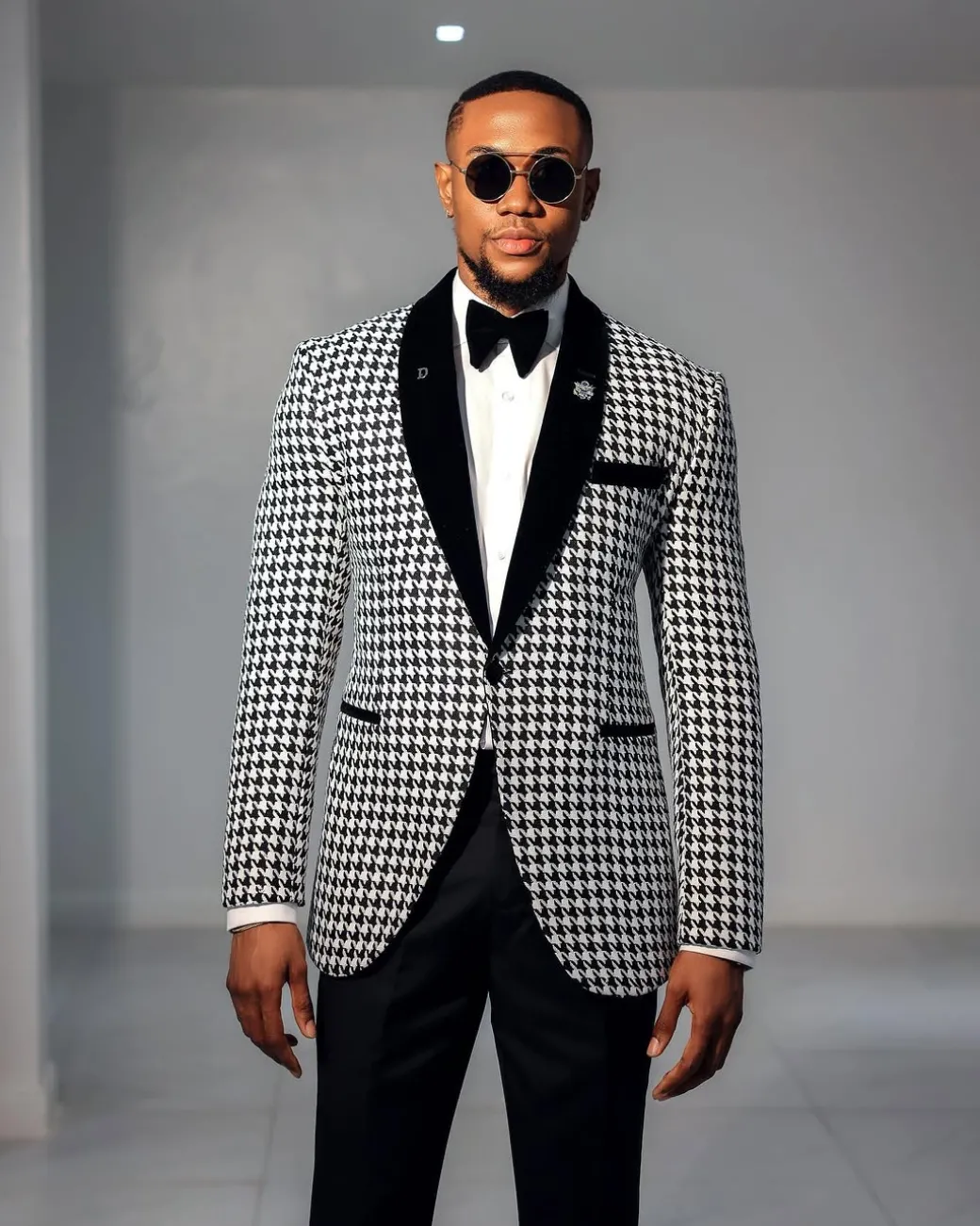 A White and black houndstooth, velvet shawl lapel tuxedo suit