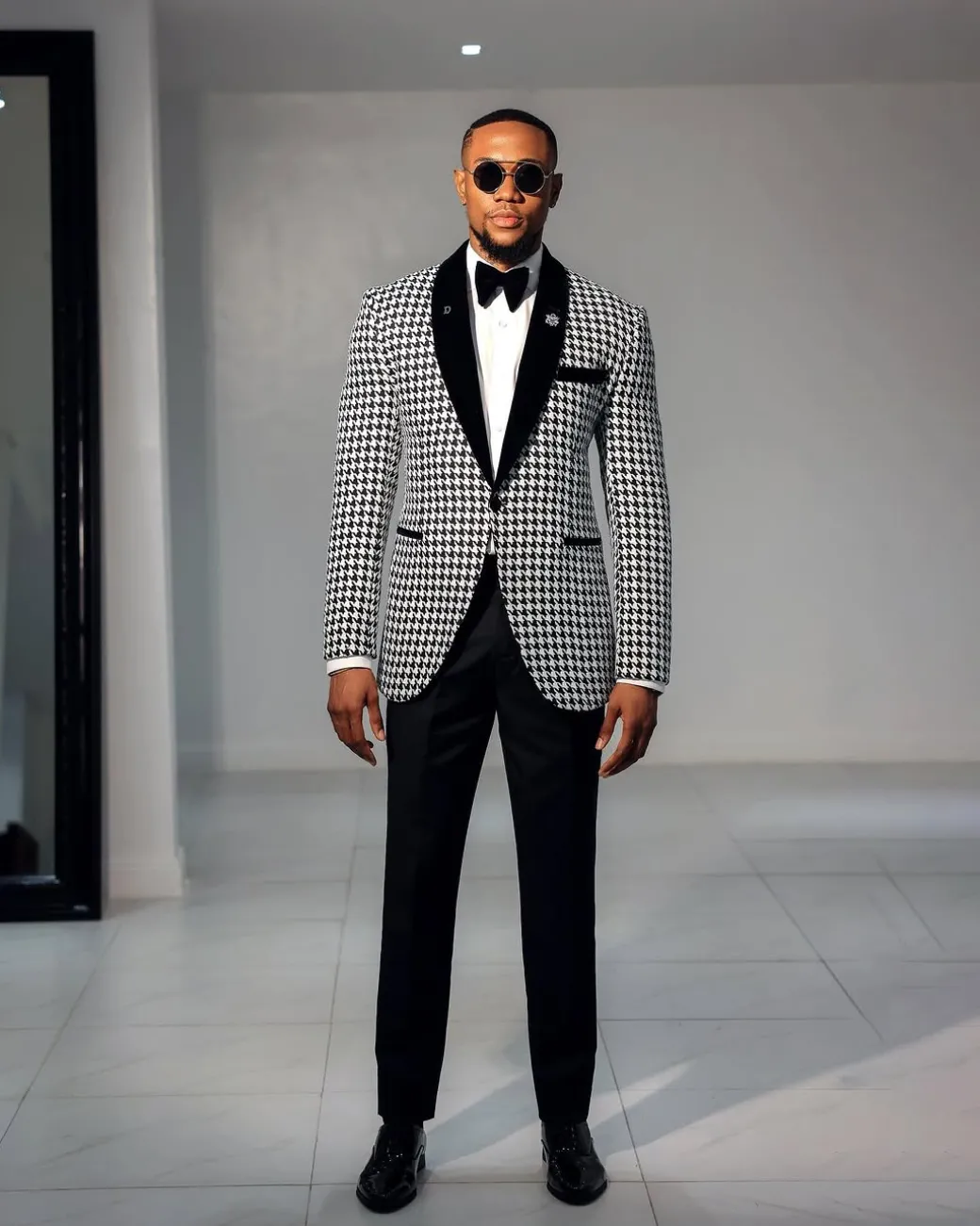 A White and black houndstooth, velvet shawl lapel tuxedo suit