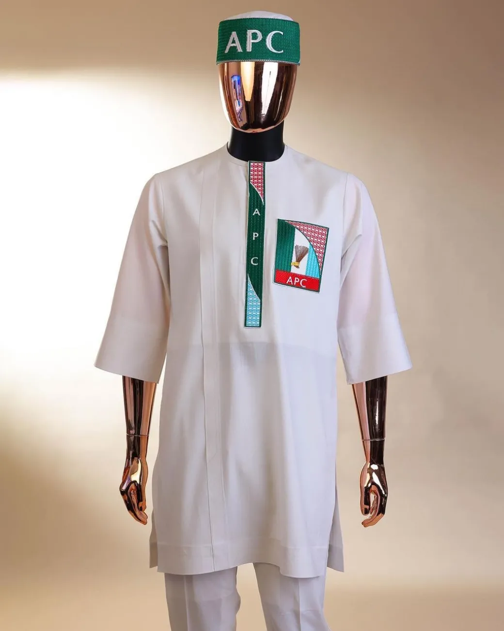A white, APC ( All Progressive Congress) pattern embroidery, 3/4 sleeve African senator kaftan native.