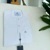 A white, clear view, transparent Swarovski buttons, front flap, and patch pocket detail African traditional senator Kaftan native.