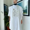 A white, connected faces renaissance maze embroidery details agbada