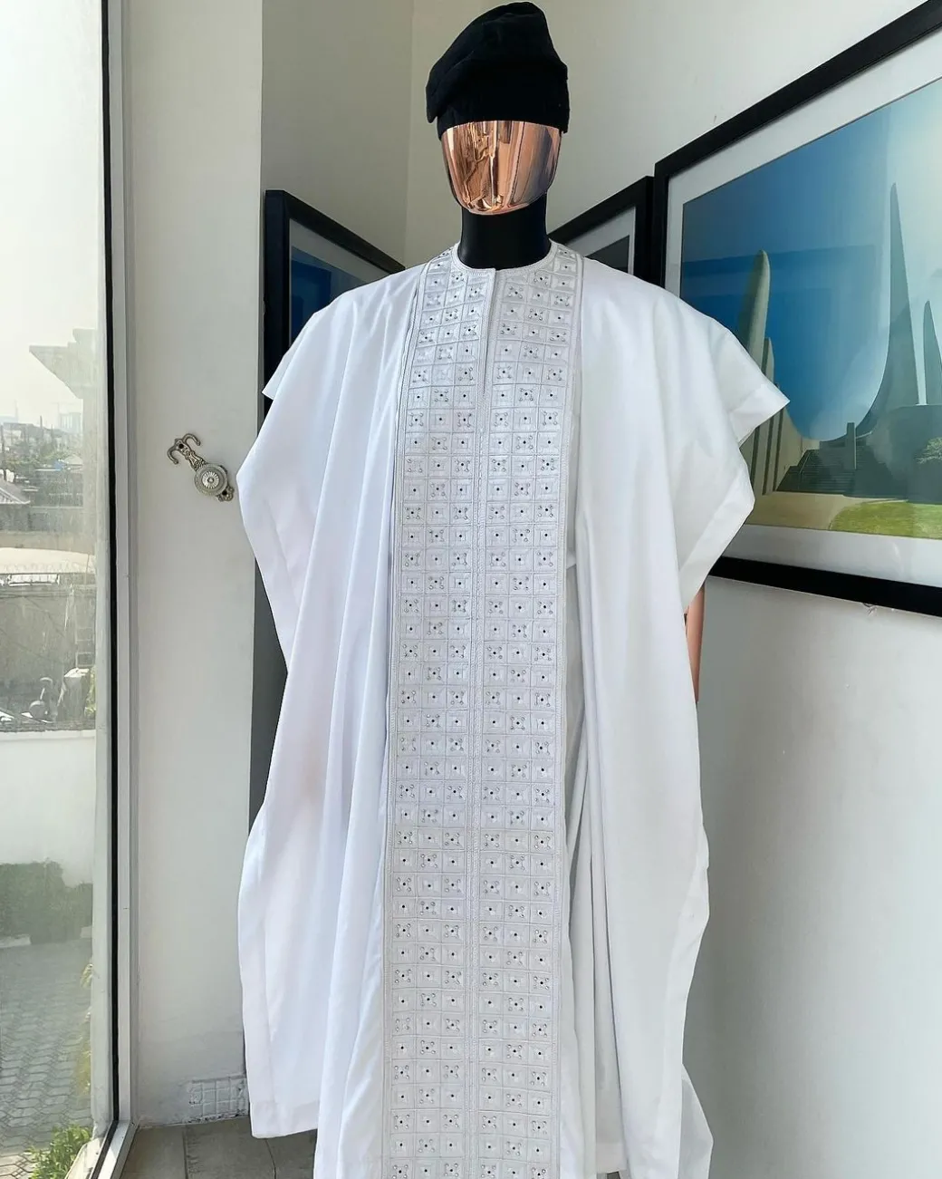A white, connected square embroidery design with matching silver and black Swarovski stone details agbada