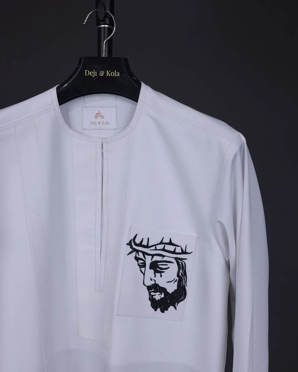 A white, front flap, Zip line with crown to Golgotha embrodery details African senator kaftan native.