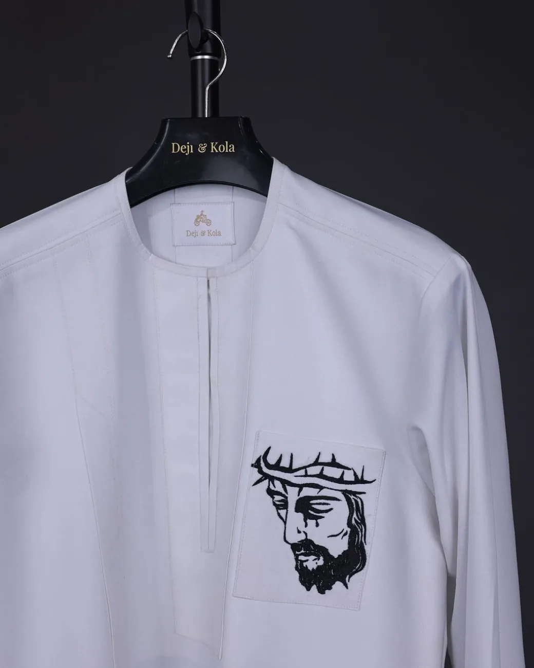 A white, front flap, Zip line with crown to Golgotha embrodery details African senator kaftan native.