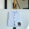 A white mix kaftan, button front flap, hand embroidery patch and black Swarovski detailing African Kaftan and Sokoto