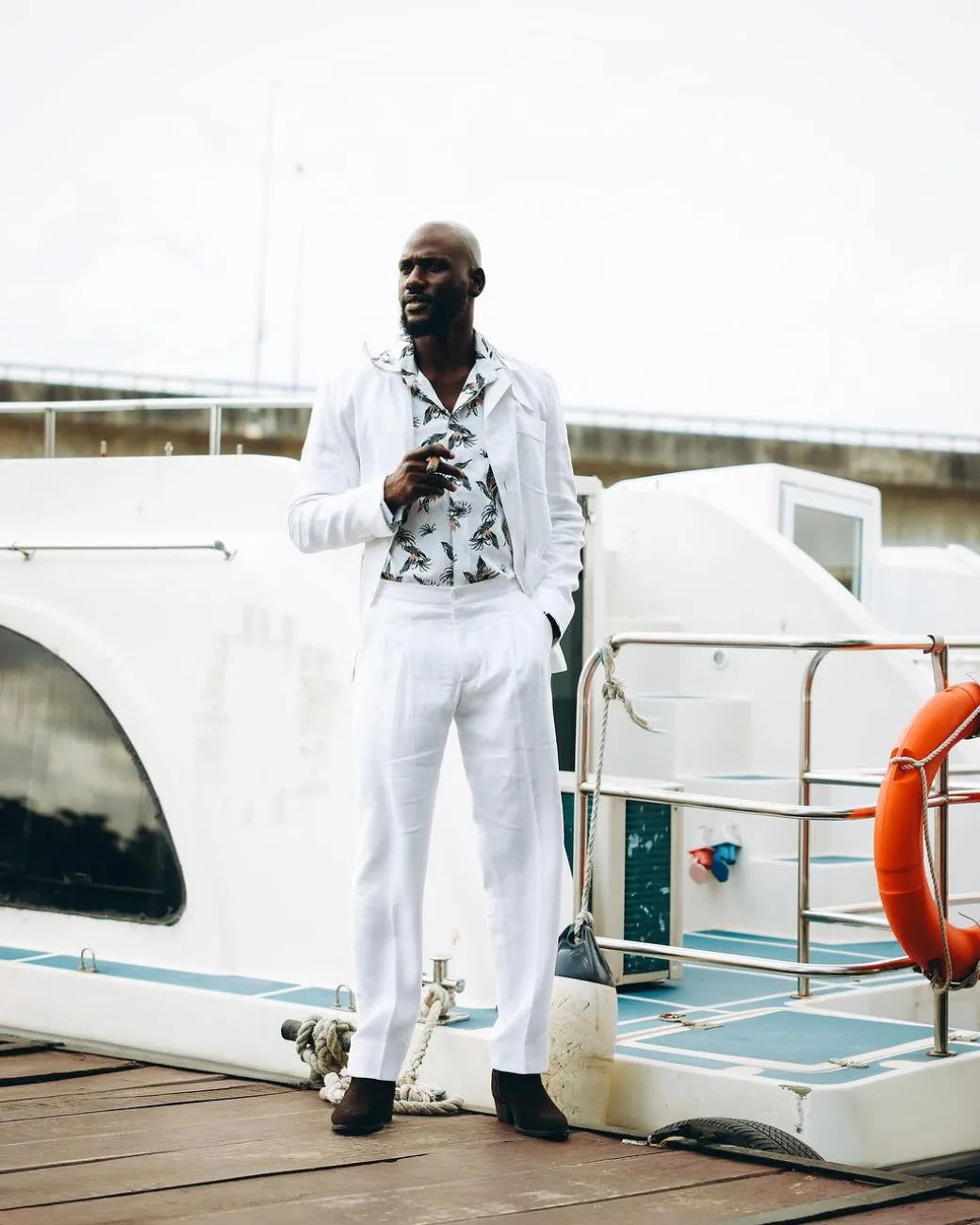A White “Tropicana” Linen Overcoat & Wide Cut Pant Trousers.