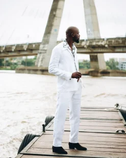 A White “Tropicana” Linen Overcoat & Wide Cut Pant Trousers.