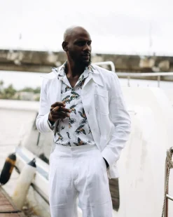 A White “Tropicana” Linen Overcoat & Wide Cut Pant Trousers.