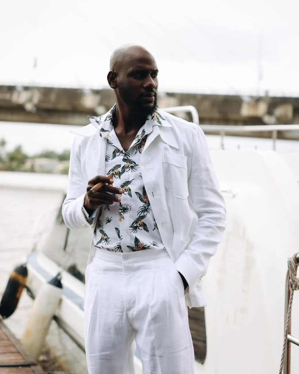 A White “Tropicana” Linen Overcoat & Wide Cut Pant Trousers.