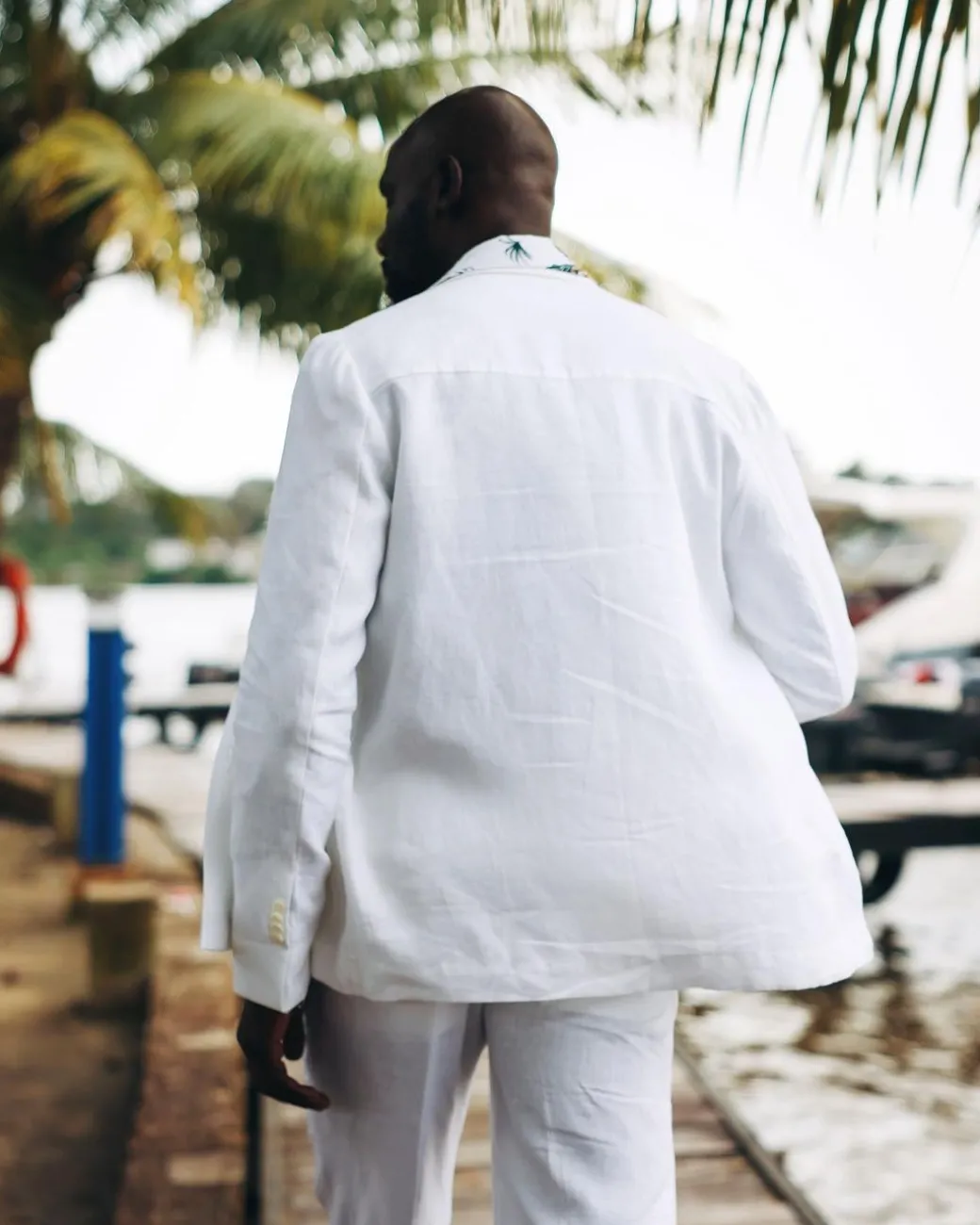 A White “Tropicana” Linen Overcoat & Wide Cut Pant Trousers.