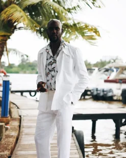 A White “Tropicana” Linen Overcoat & Wide Cut Pant Trousers.
