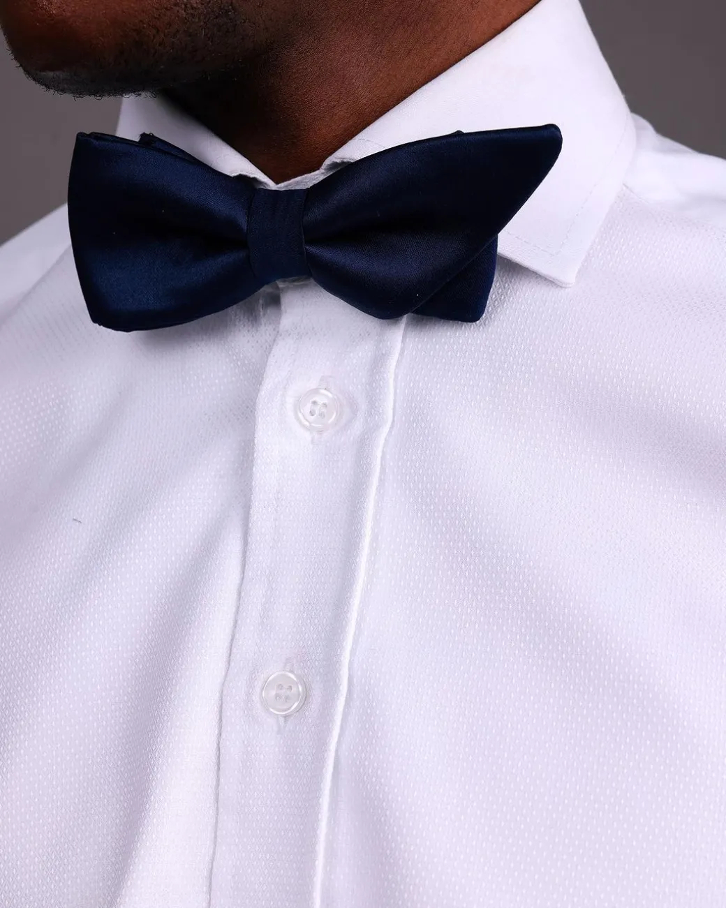 A White, Tuxedo Shirt With Dotted Front Details.