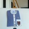 A Windowpane check blue and white mix front flap, hand embroidery patch detailing, and a red Swarovski African Kaftan and Sokoto