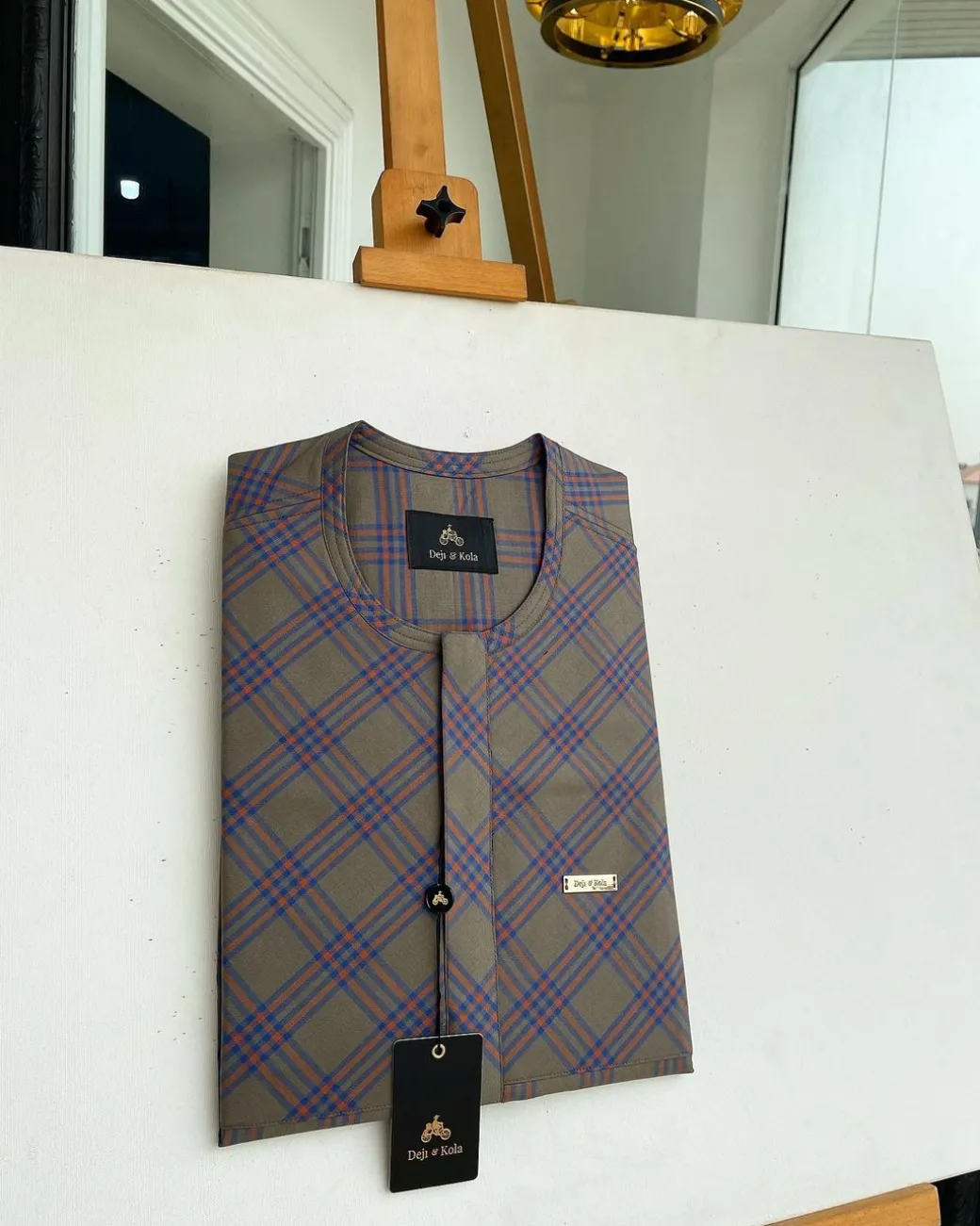 A windowpane tortilla brown with orange and navy blue stripes, a front flap detailing African traditional senator kaftan native.