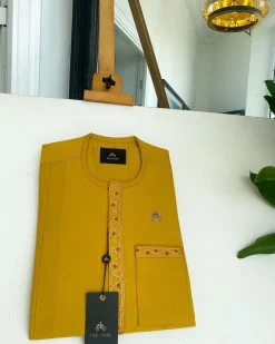 A Yellow, embroidery front flap, and patch pocket detail African traditional senator Kaftan native.